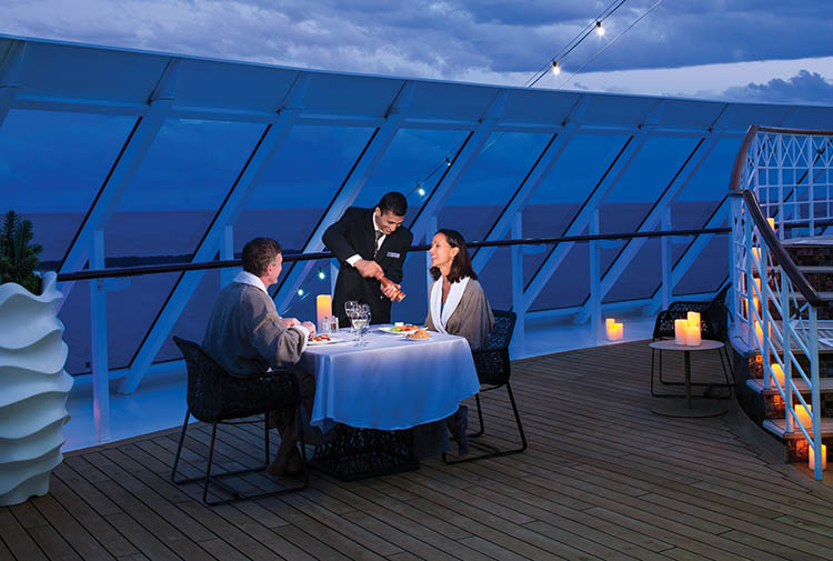 Couple enjoy dinner under the stars aboard a cruise ship