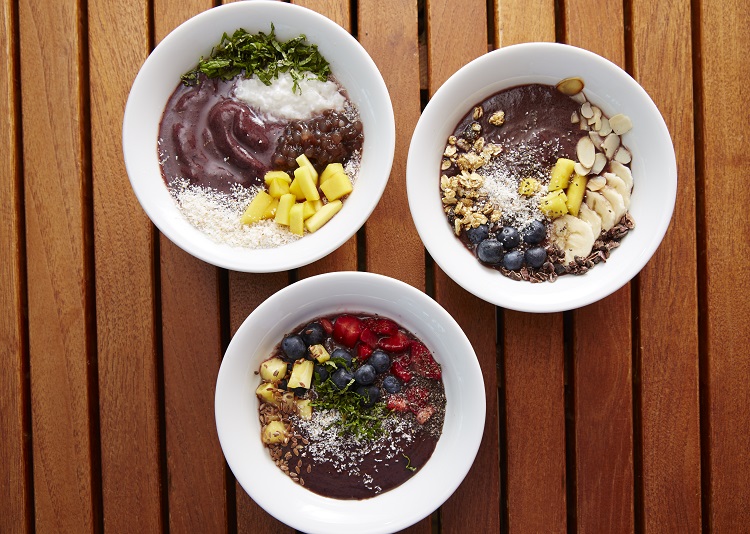 Acai bowls topped with fruit on a table in a restaurant on-board a Celebrity Cruises ship