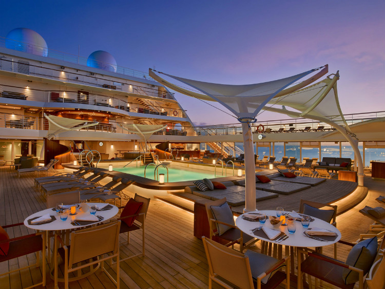 The pool-side Patio restaurant on Seabourn Ovation lit up at night