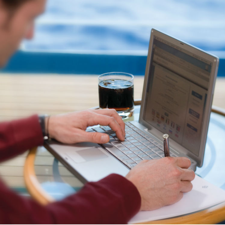 Man with laptop on-board Silversea cruise