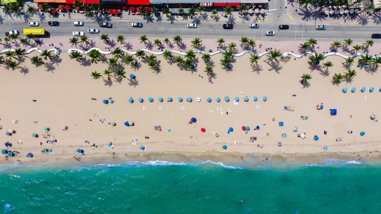 Aerial view of sun loungers and travellers on a Miami beach