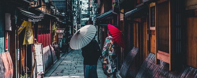 Geisha girls strolling down a street in Japan