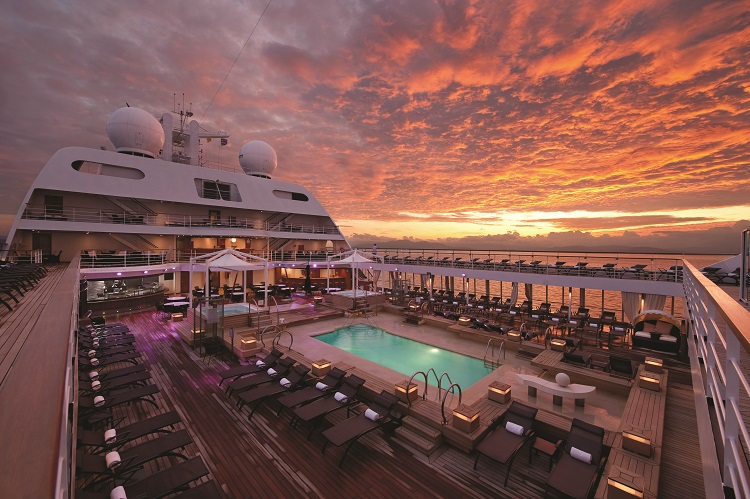 The pool deck on a Seabourn cruise ship at sunset