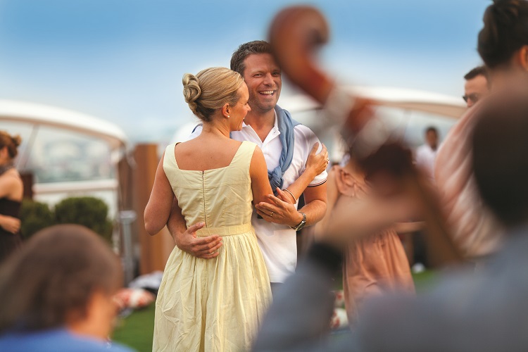 Couple dancing on the Lawn deck on-board Celebrity Eclipse