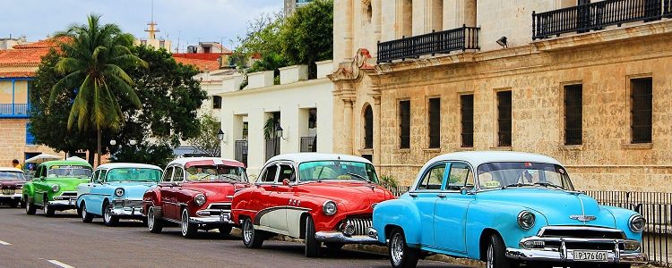 Classic cars lining a street of colonial buildings in Havana