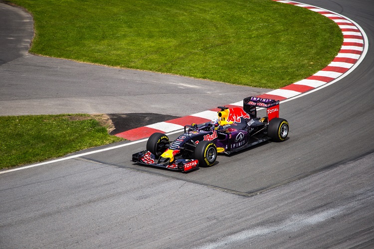 A Red Bull race car soaring around a track during the F1 Grand Prix