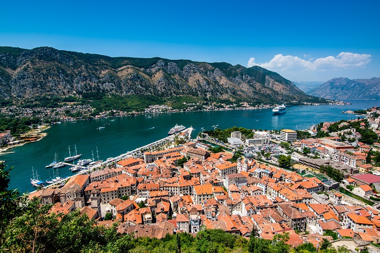 A fjord bordered by mountains and terracotta houses in Kotor, Montenegro