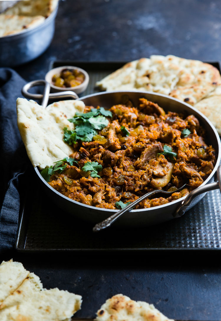 An authentic Indian chicken karahi served with naan bread