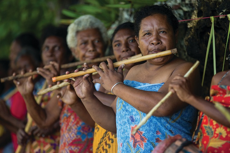 A South Pacific tribe playing music for passengers during an expedition cruise