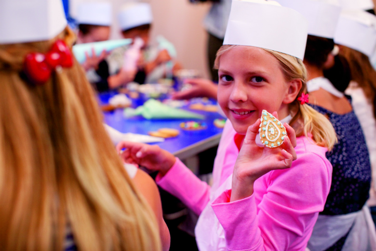 Children taking part in a cookie baking class on a Crystal Cruises ship