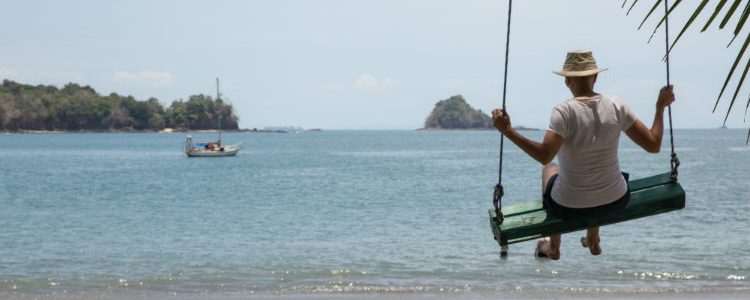 Man swinging on the beach - Silversea Cruises